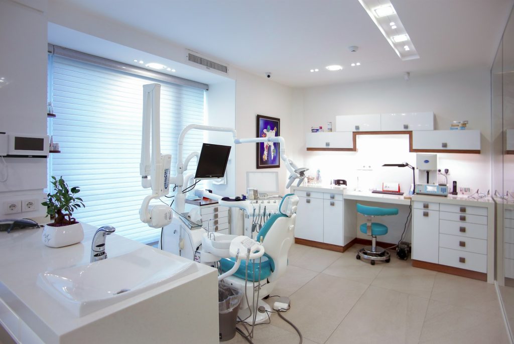 Modern dental clinic treatment room with chair and equipment