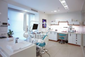 Modern dental clinic treatment room with chair and equipment