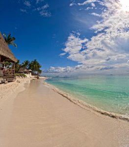 Playa del Carmen beach with palapa roof by the Caribbean sea